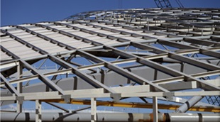 Curved light steel purlins made from GALVASPAN® steel create the Velodrome's distinctive shell-shaped roof structure. It is covered by ZINCALUME® zinc/aluminium alloy coated steel rollformed into Lysaght LONGLINE 305 sheeting in specifically tapered lengths of more than 24 metres.
