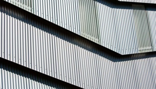 The cladding is LYSAGHT CUSTOM ORB® profile made from COLORBOND® steel in the colours Axis® and Conservatory®, which alternate vertically on the northern face.