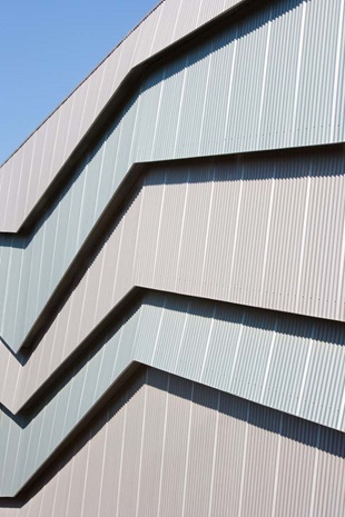 The cladding is LYSAGHT CUSTOM ORB® profile made from COLORBOND® steel in the colours Axis® and Conservatory®, which alternate vertically on the northern face.