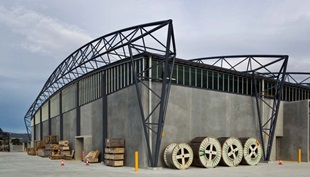 The roof made from COLORBOND® steel is suspended below the curving roof trusses, which reduced the external wall area by about 900m2 to achieve significant cost savings.