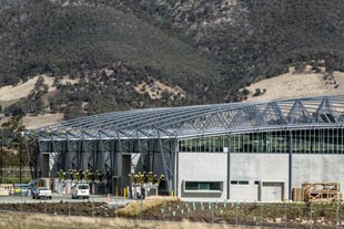 The roof made from COLORBOND® steel is suspended below the curving roof trusses, which reduced the external wall area by about 900m2 to achieve significant cost savings.